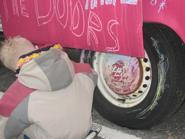 People writing on the side of George's bus