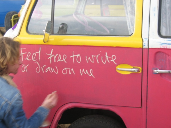 George writing on the side of his bus